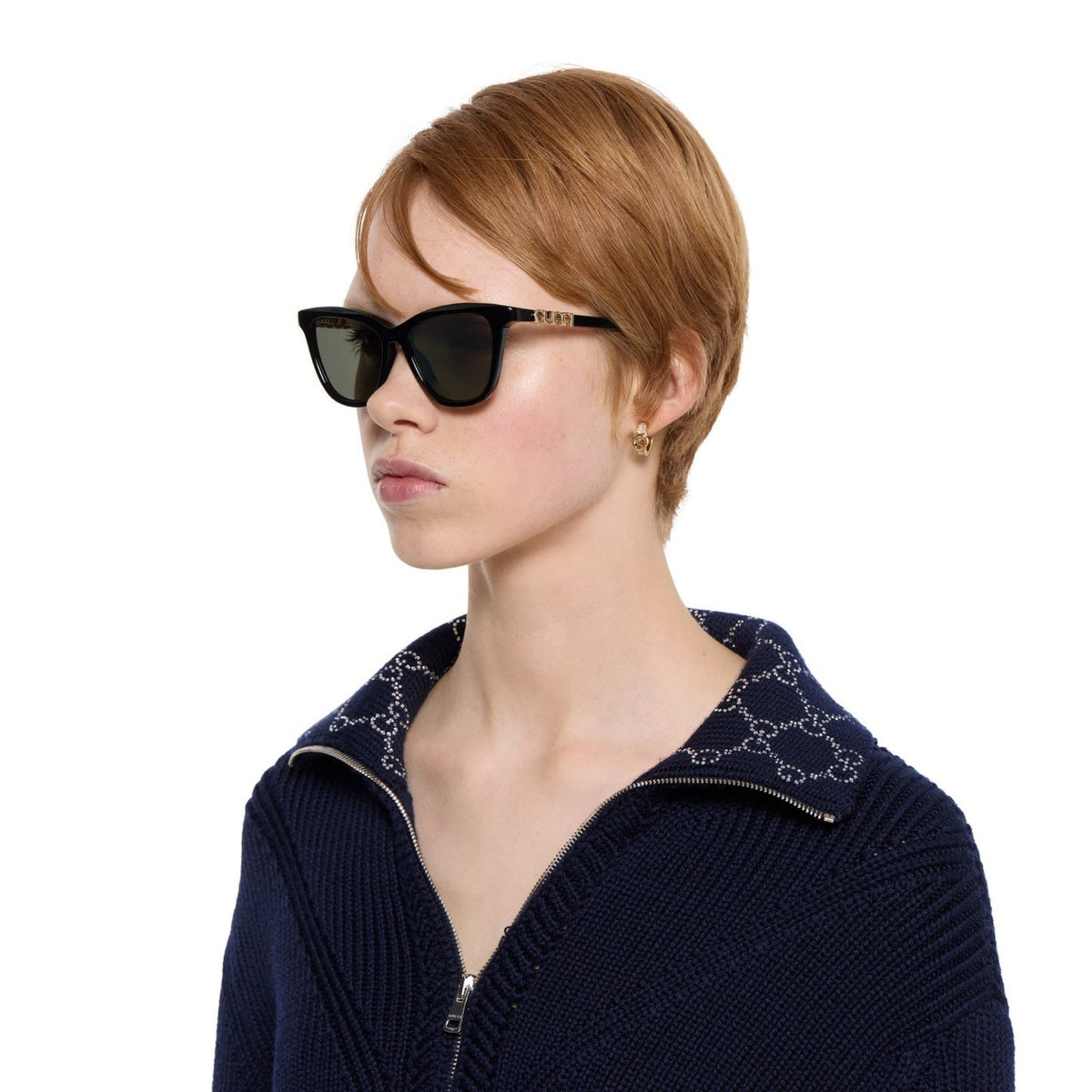 Woman wearing Gucci GG2032S black cat-eye sunglasses