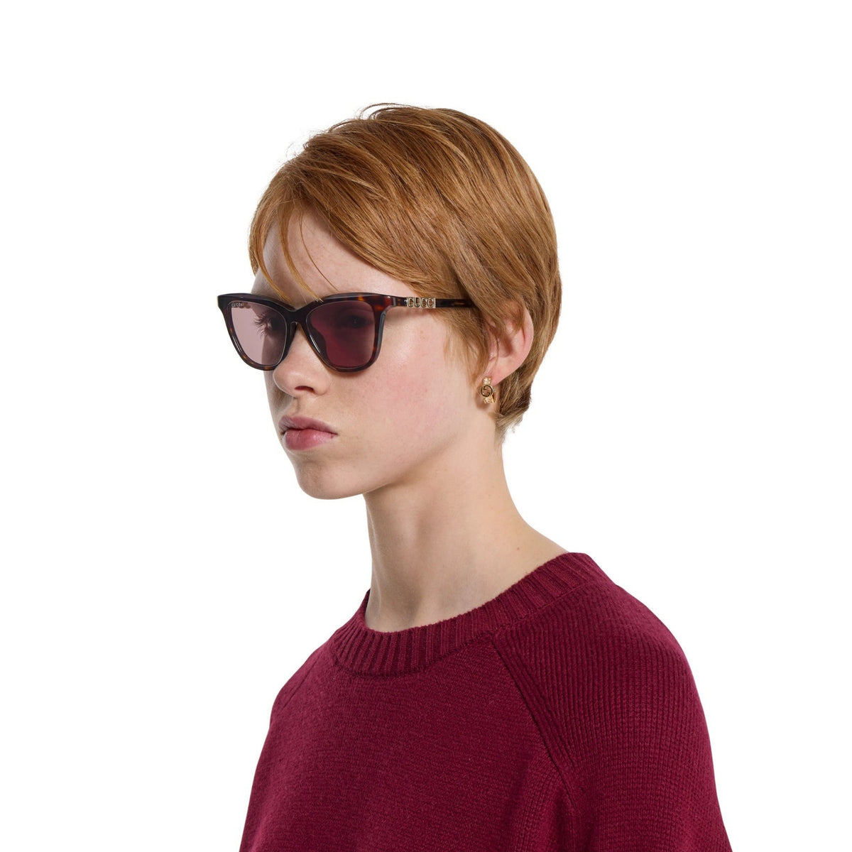 Woman wearing Gucci GG2032S havana cat-eye sunglasses
