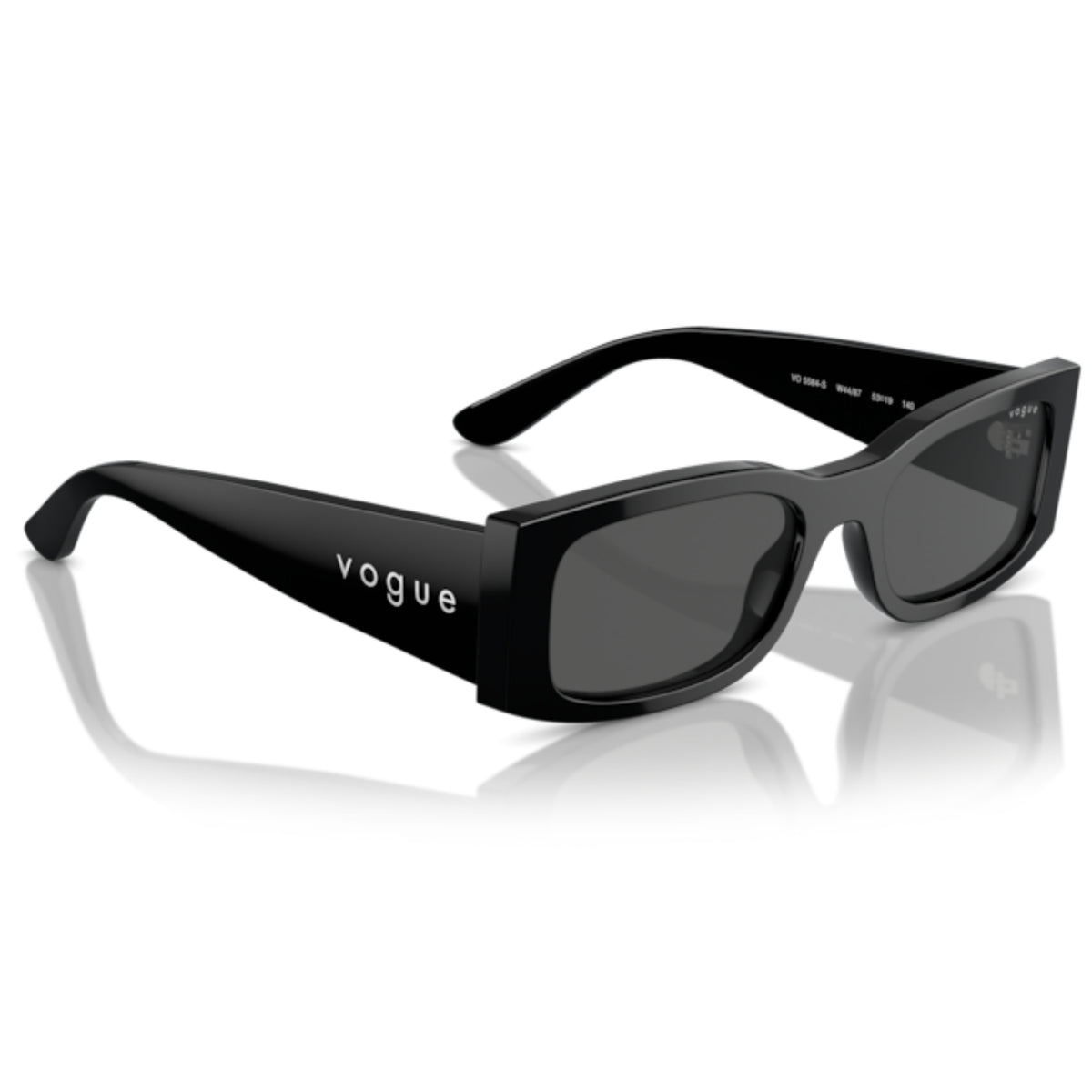 Vogue black cat-eye sunglasses with dark tinted lenses and the Vogue logo printed on the temple arm, shown on a reflective white surface.